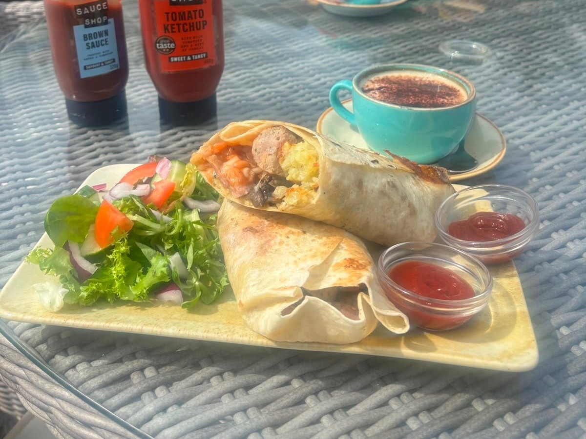 Breakfast burrito with salad and hot drink in the Dovecote garden