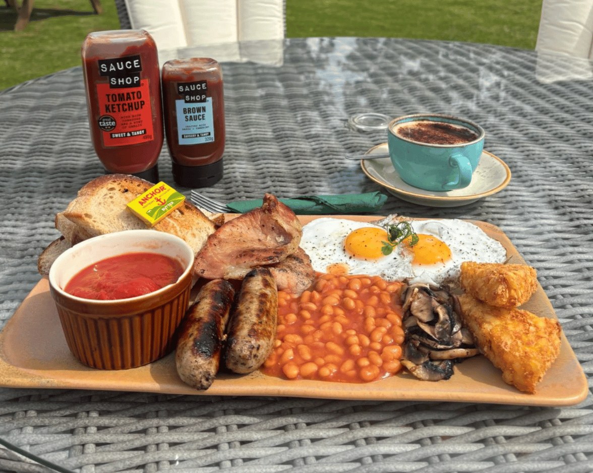 A full farmers breakfast with sausages, bacon, eggs and beans served at The Dovecote Barn