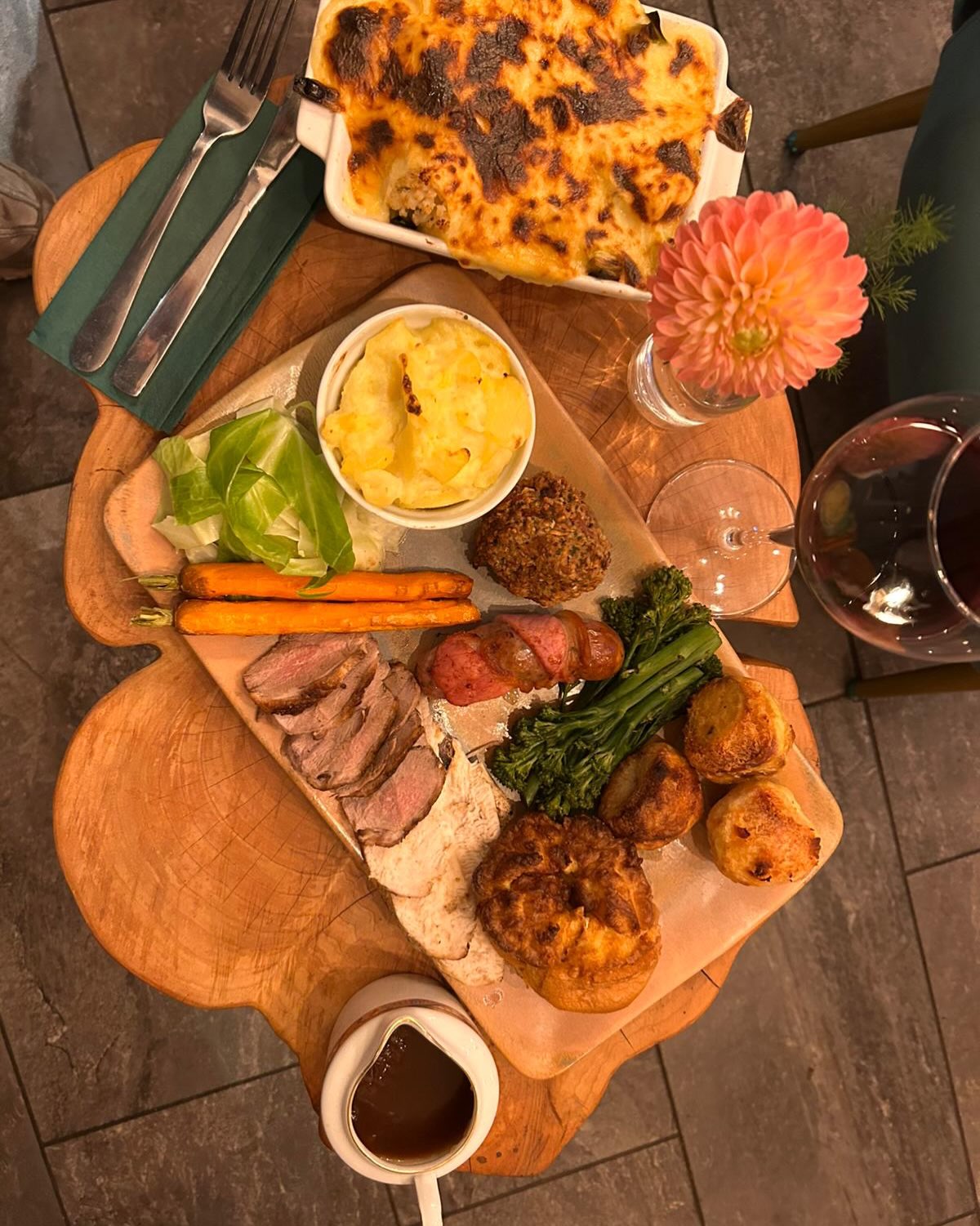 Sliced home-reared steak on a wooden board with tomatoes